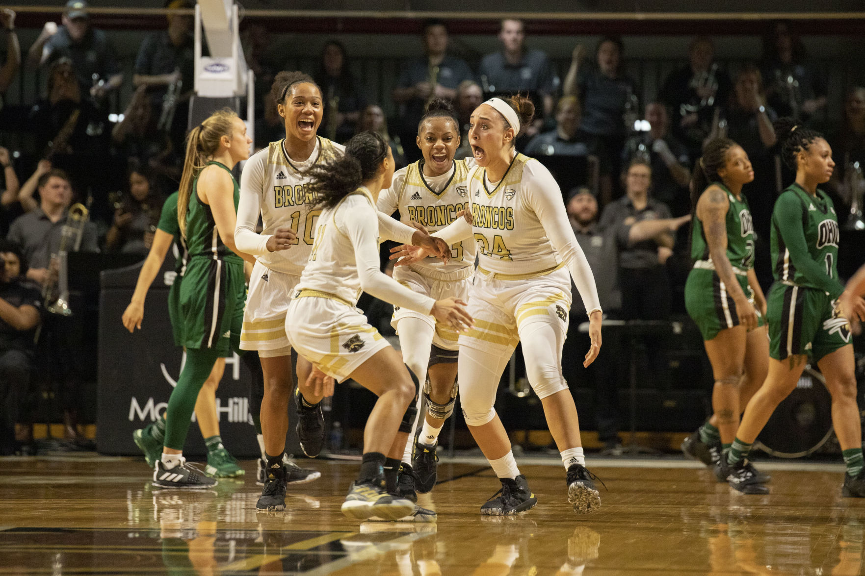 Teammates surround a stunned Leighah-Amori Wool